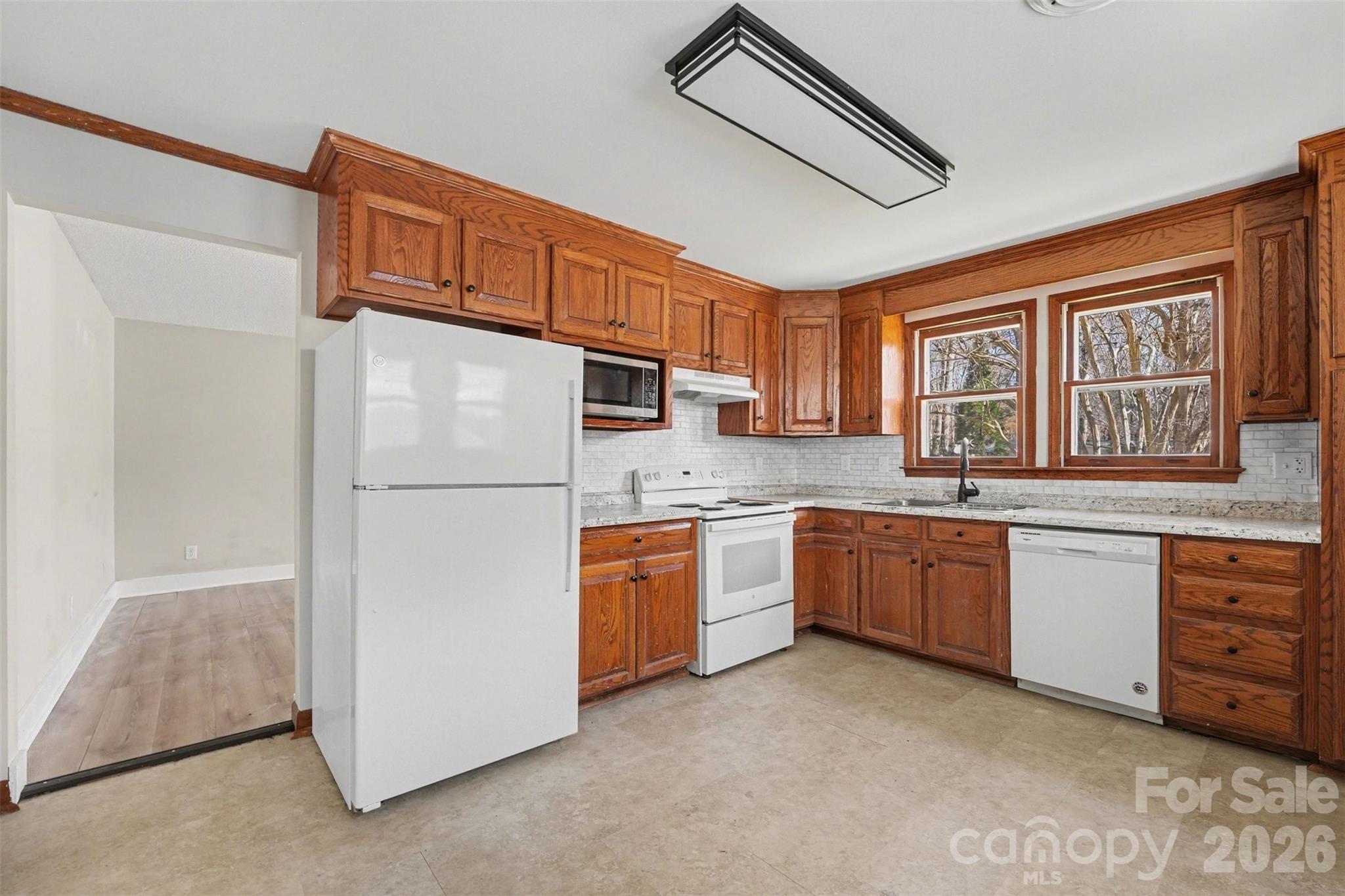1440 Majolica Road Salisbury, NC 28147 - Photo 12 of 25 a kitchen with granite countertop a refrigerator stove top oven and sink