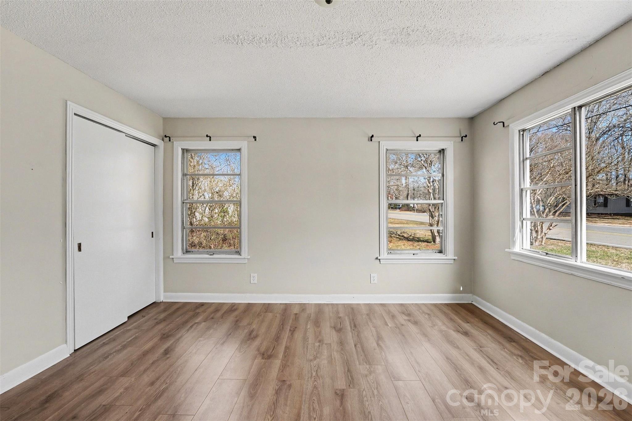 1440 Majolica Road Salisbury, NC 28147 - Photo 13 of 25 a view of an empty room with wooden floor and a window