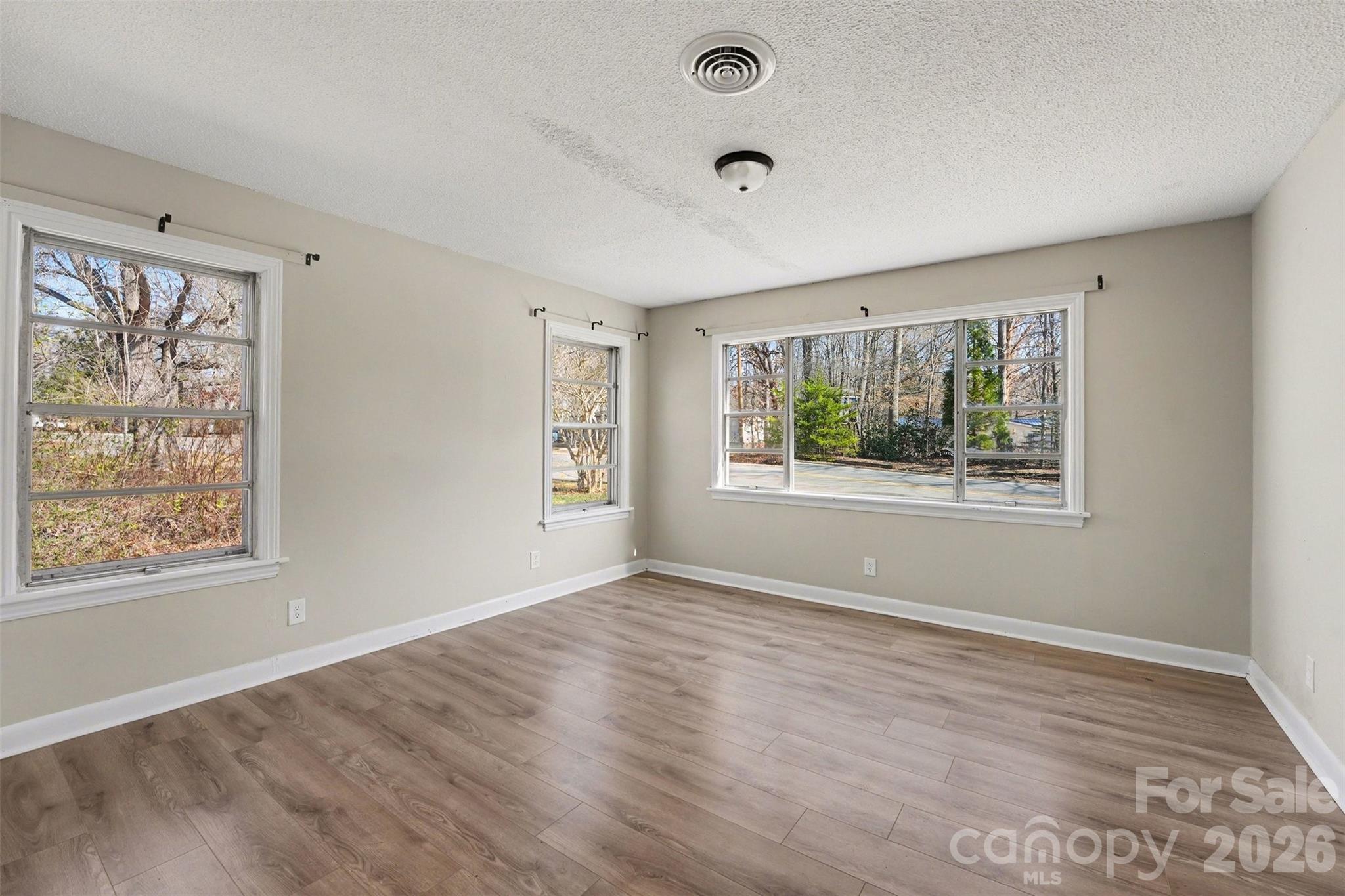 1440 Majolica Road Salisbury, NC 28147 - Photo 14 of 25 a view of an empty room with wooden floor and a window
