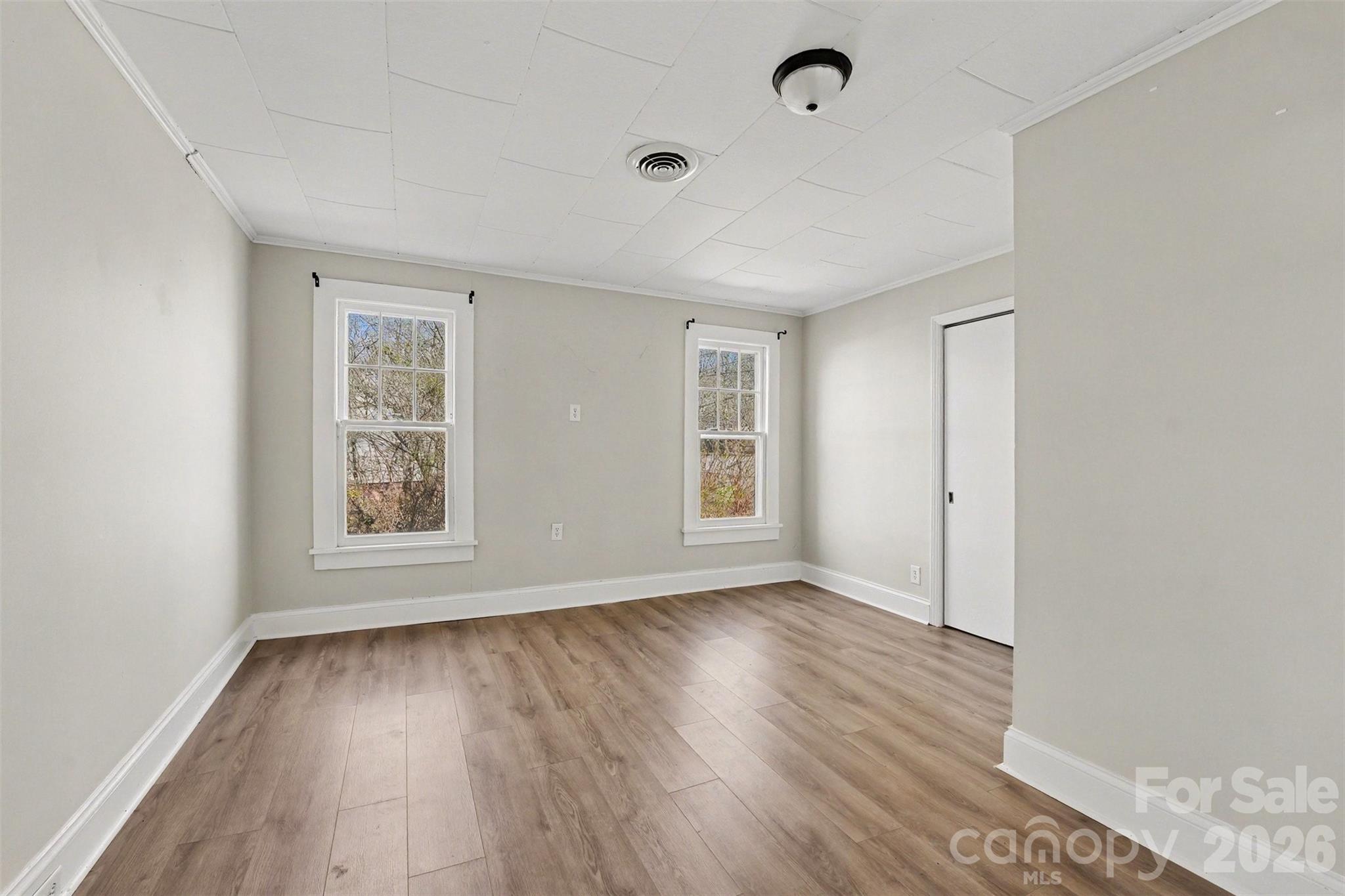 1440 Majolica Road Salisbury, NC 28147 - Photo 15 of 25 an empty room with wooden floor and windows