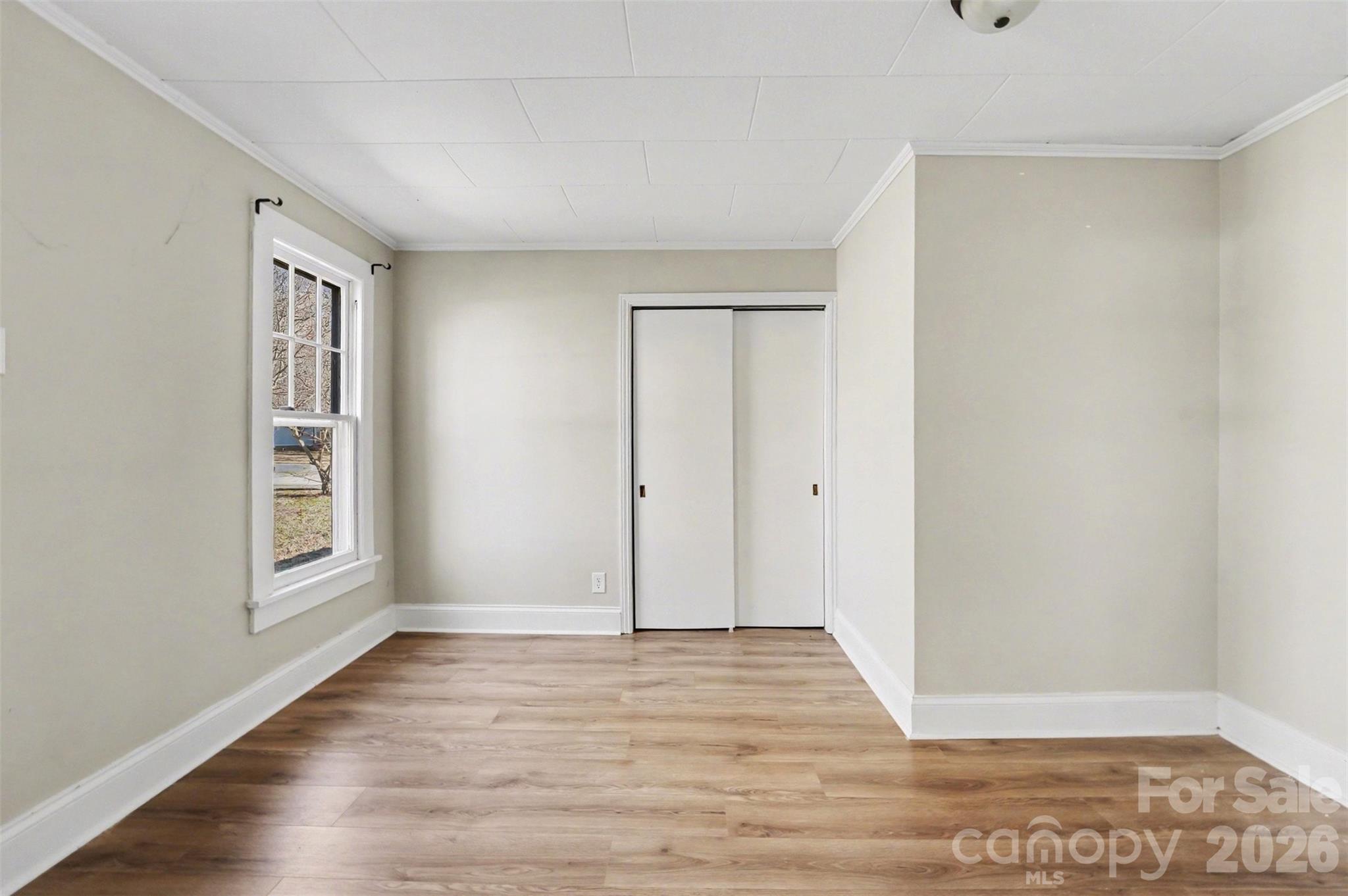 1440 Majolica Road Salisbury, NC 28147 - Photo 16 of 25 an empty room with wooden floor and windows