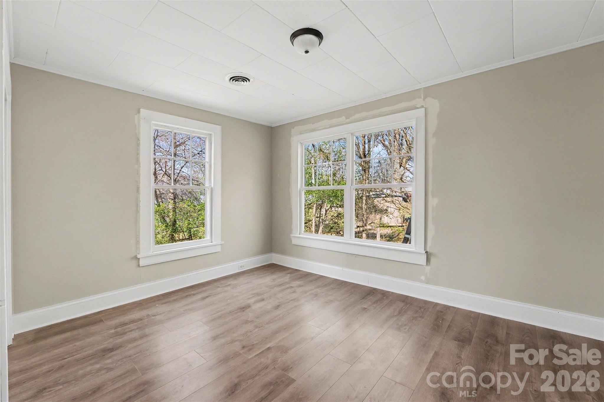 1440 Majolica Road Salisbury, NC 28147 - Photo 17 of 25 a view of an empty room with wooden floor and a window