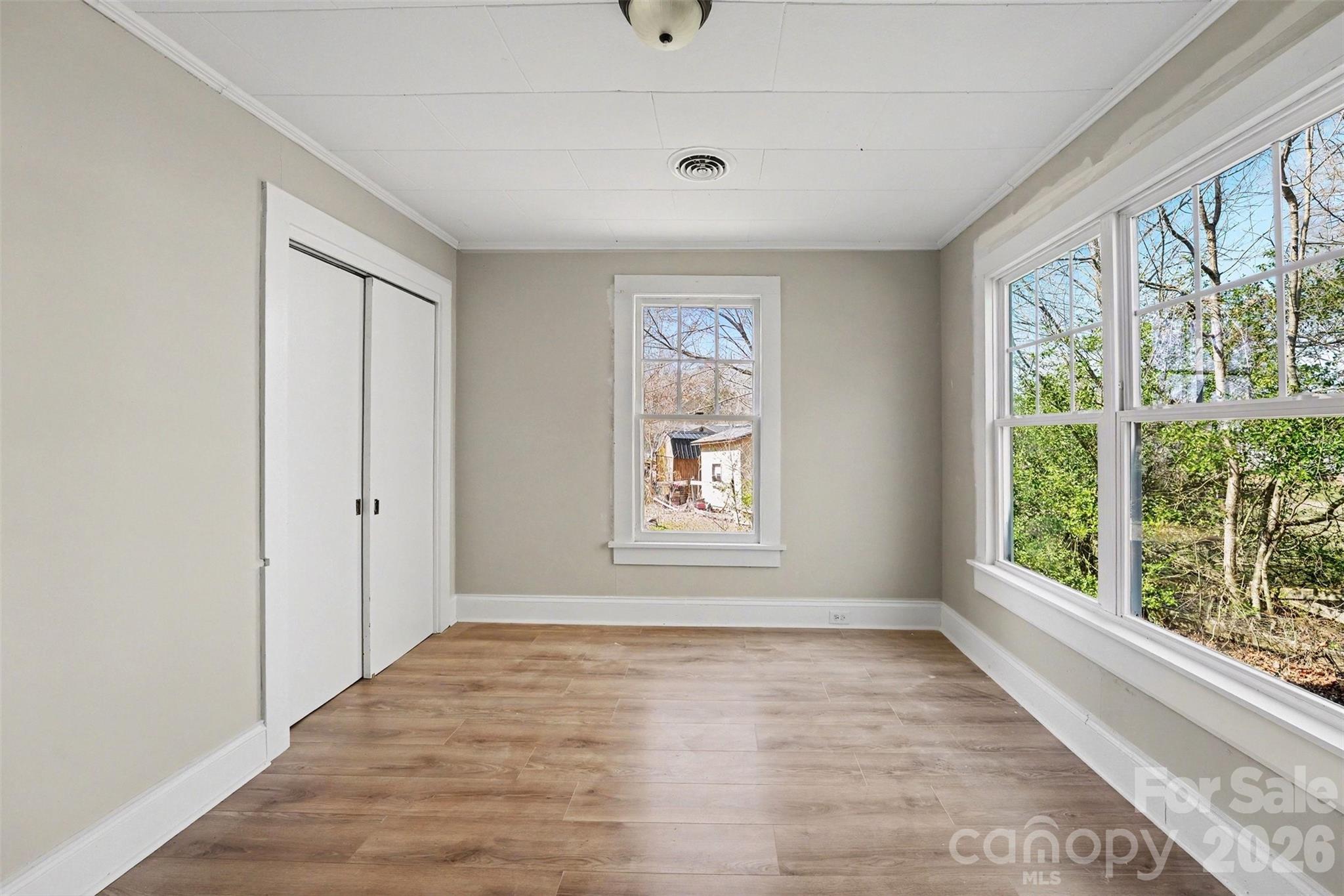 1440 Majolica Road Salisbury, NC 28147 - Photo 18 of 25 a view of an empty room with wooden floor and a window