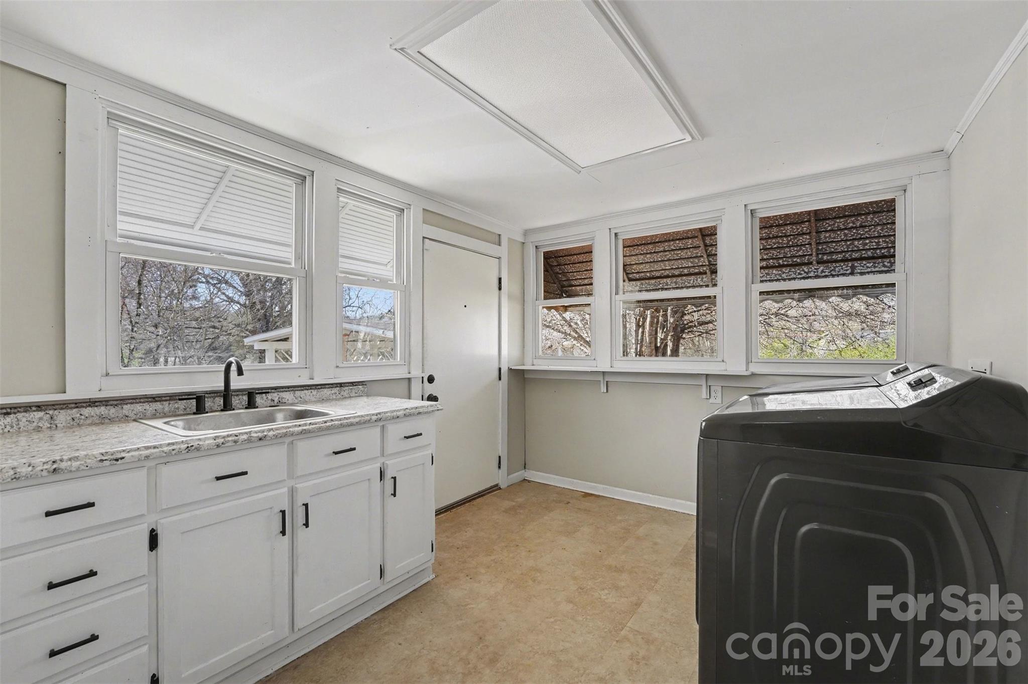 1440 Majolica Road Salisbury, NC 28147 - Photo 20 of 25 a utility room with stainless steel appliances granite countertop a stove a sink and a window