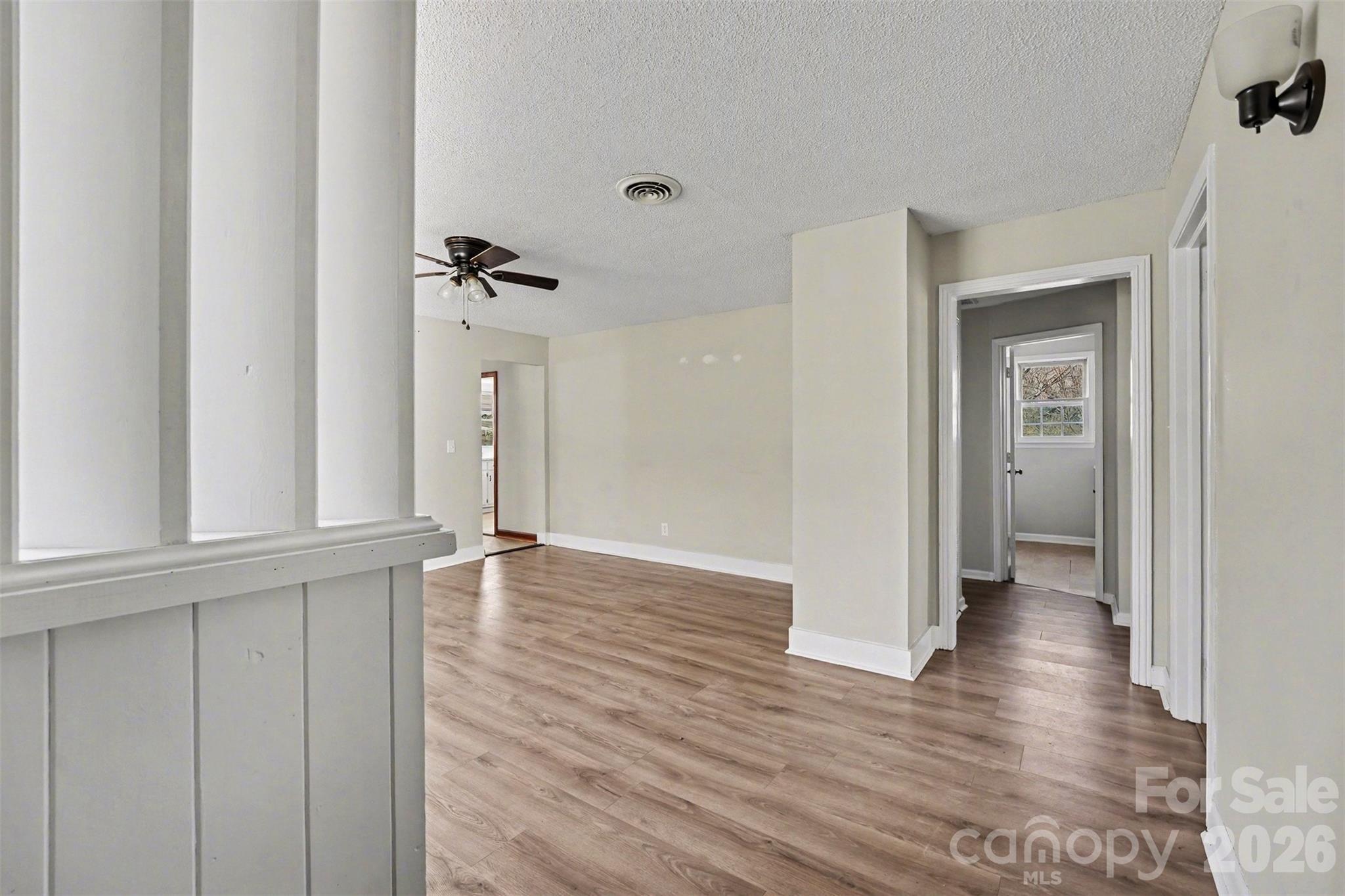 1440 Majolica Road Salisbury, NC 28147 - Photo 9 of 25 a view of an empty room with wooden floor and a window