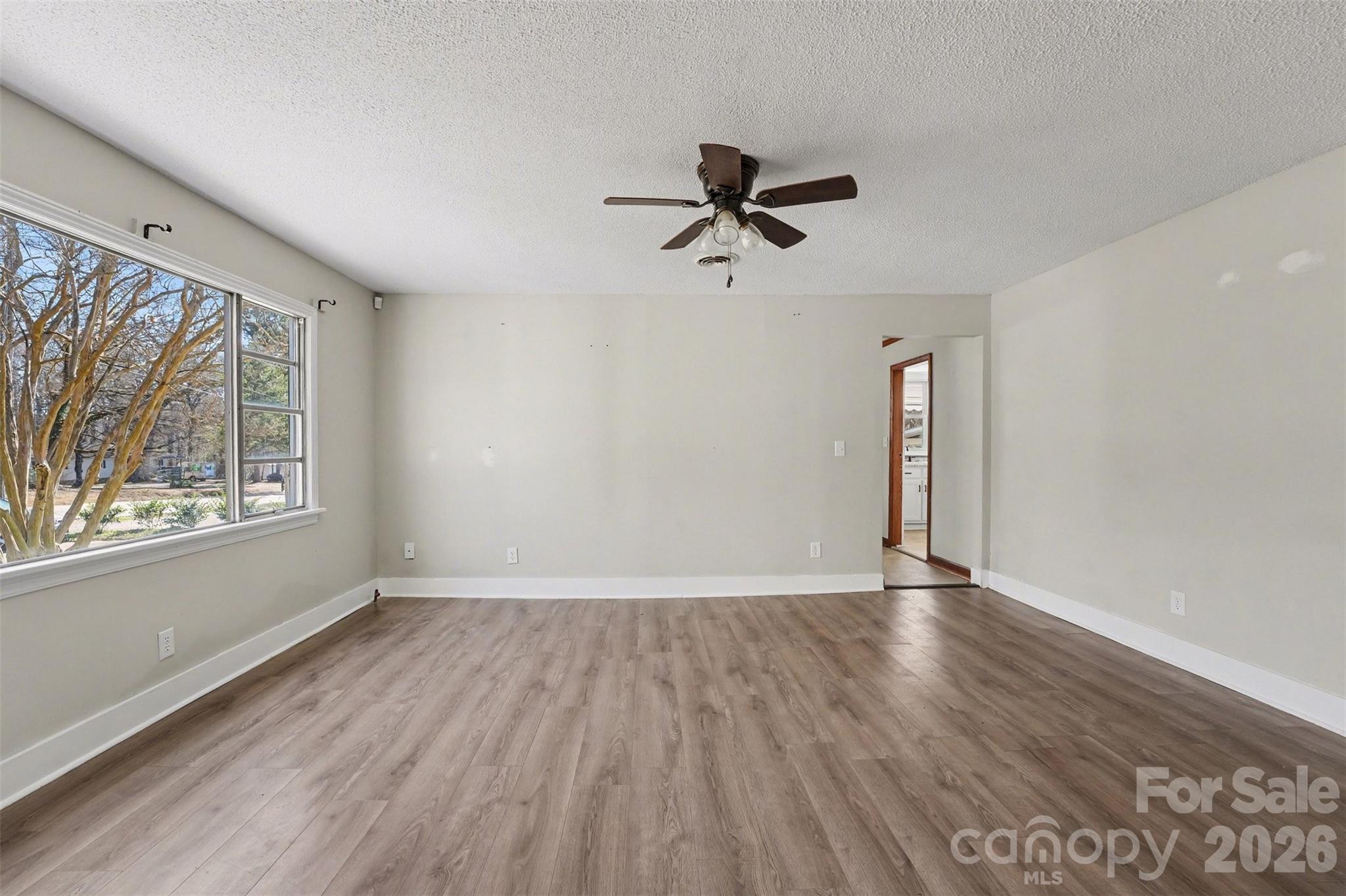1440 Majolica Road Salisbury, NC 28147 - Photo 10 of 25 a view of an empty room with a window and wooden floor