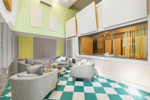 a living room with furniture and a floor to ceiling window