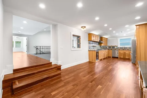 a view of kitchen with cabinets and wooden floor