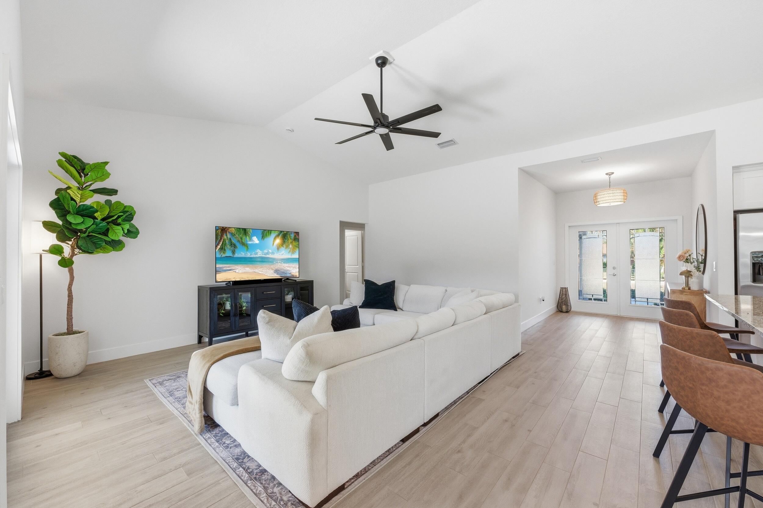 18932 42nd Road North The Acreage, FL 33470 - Photo 17 of 45 a living room with furniture a chandelier and a potted plant