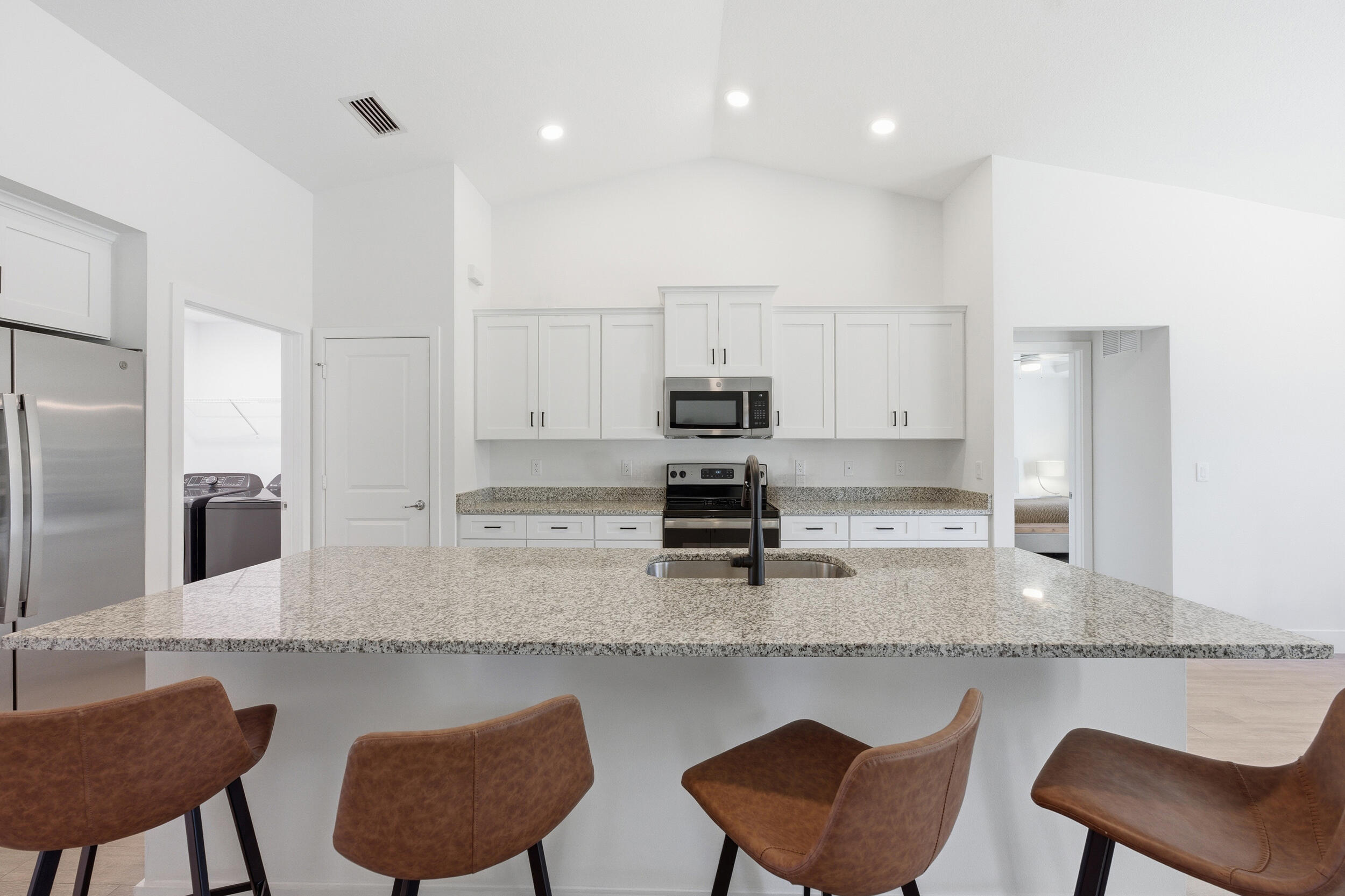 18932 42nd Road North The Acreage, FL 33470 - Photo 19 of 45 a kitchen with stainless steel appliances granite countertop a kitchen island a table and chairs in it