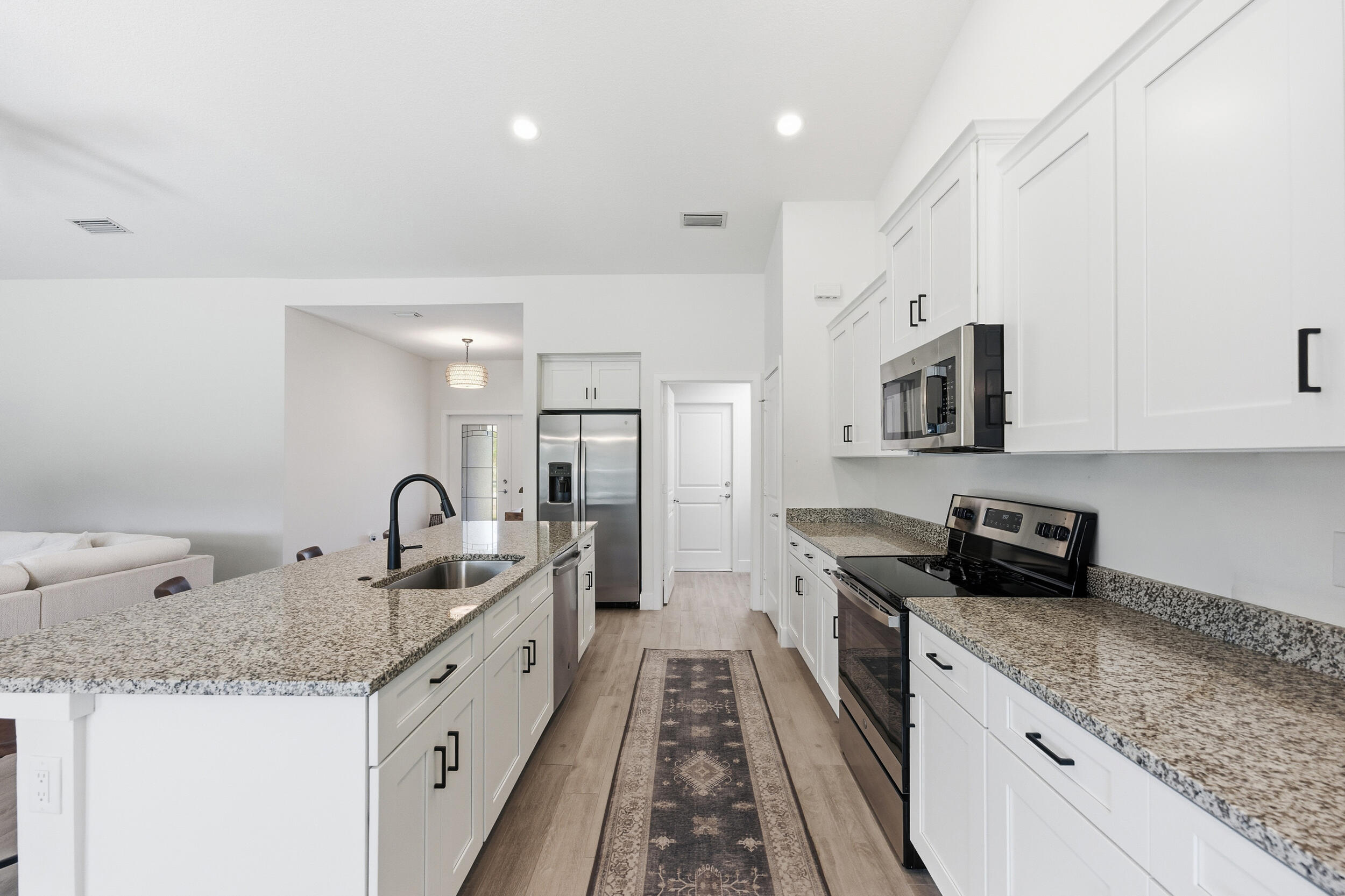 18932 42nd Road North The Acreage, FL 33470 - Photo 21 of 45 a kitchen with granite countertop a sink and cabinets