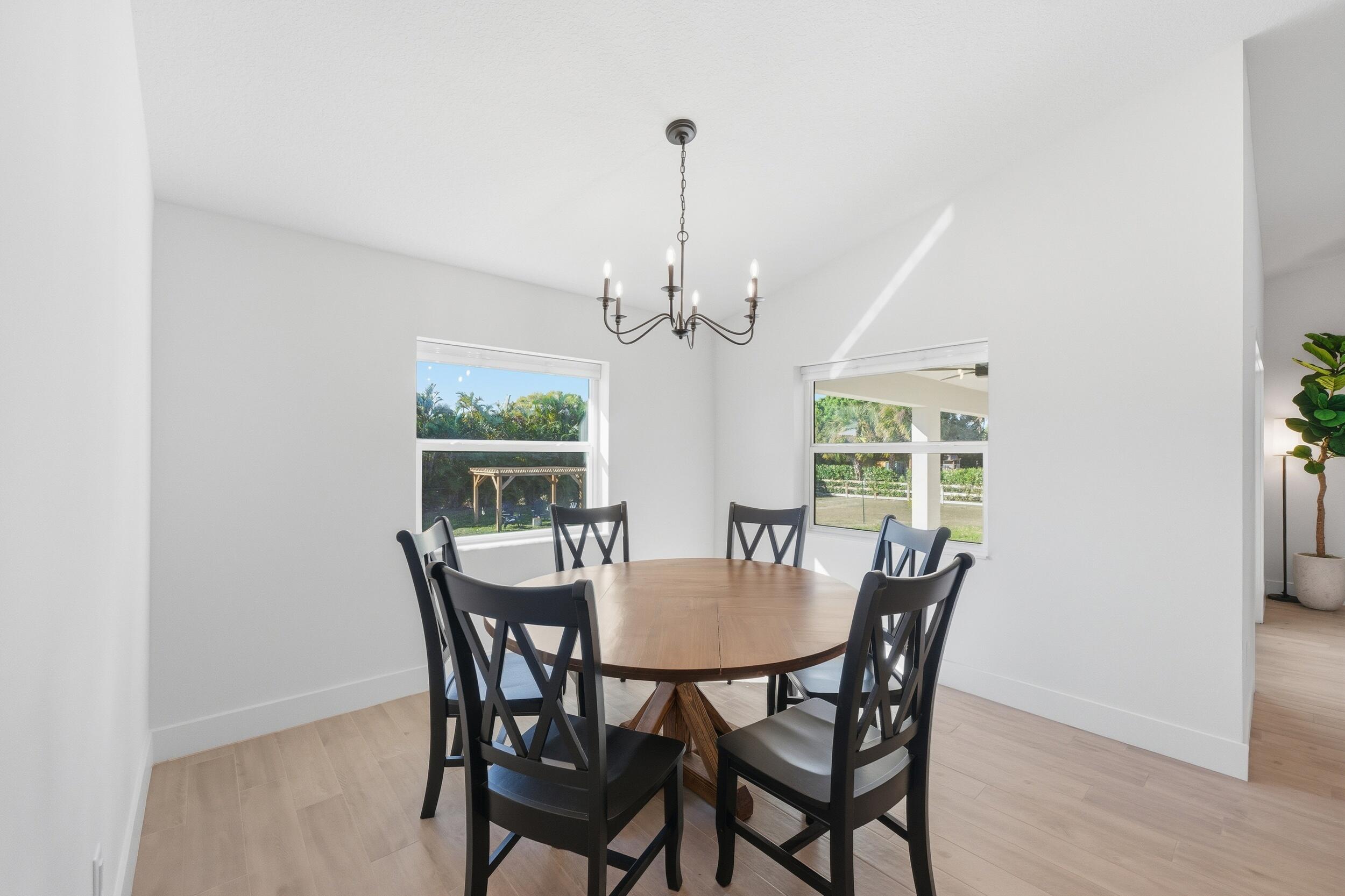 18932 42nd Road North The Acreage, FL 33470 - Photo 22 of 45 a view of a dining room with furniture window and wooden floor