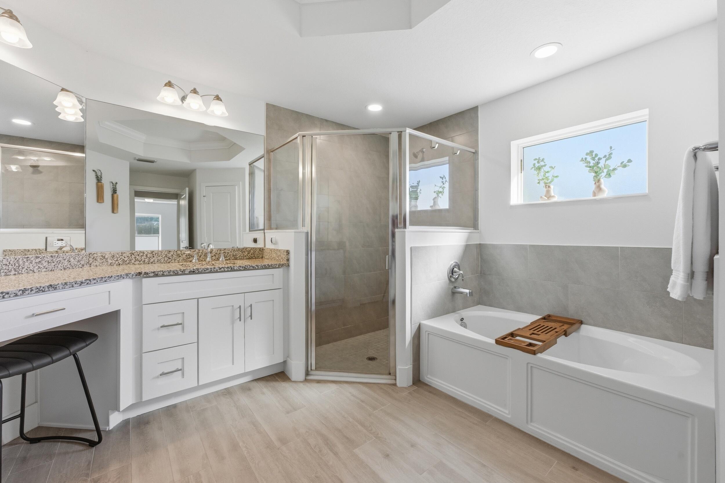 18932 42nd Road North The Acreage, FL 33470 - Photo 27 of 45 a bathroom with a tub a sink and mirror