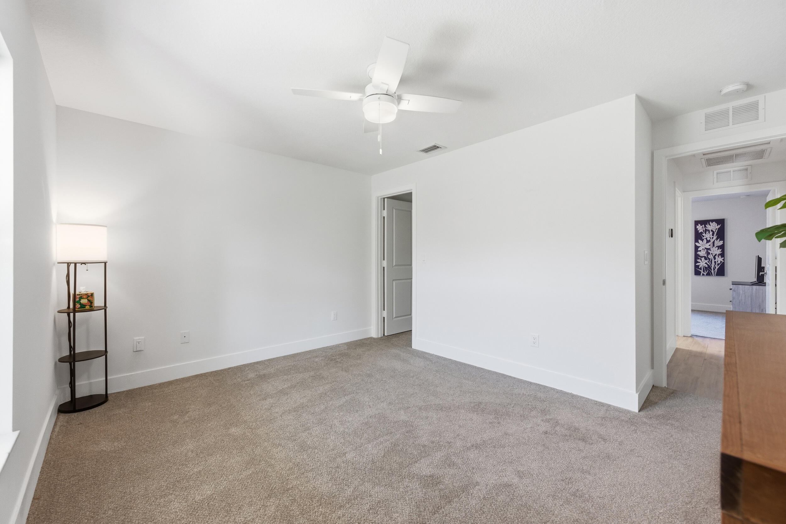 18932 42nd Road North The Acreage, FL 33470 - Photo 30 of 45 an empty room with closet and a chandelier fan