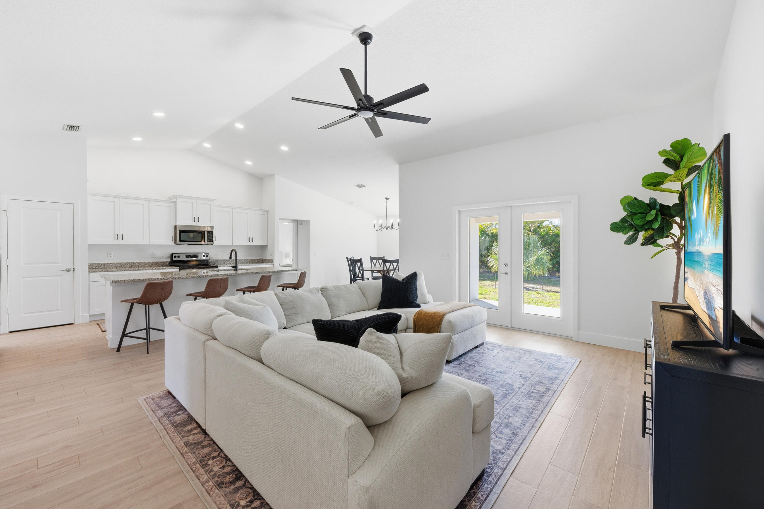 18932 42nd Road North The Acreage, FL 33470 - Photo 3 of 45 a living room with furniture and a flat screen tv