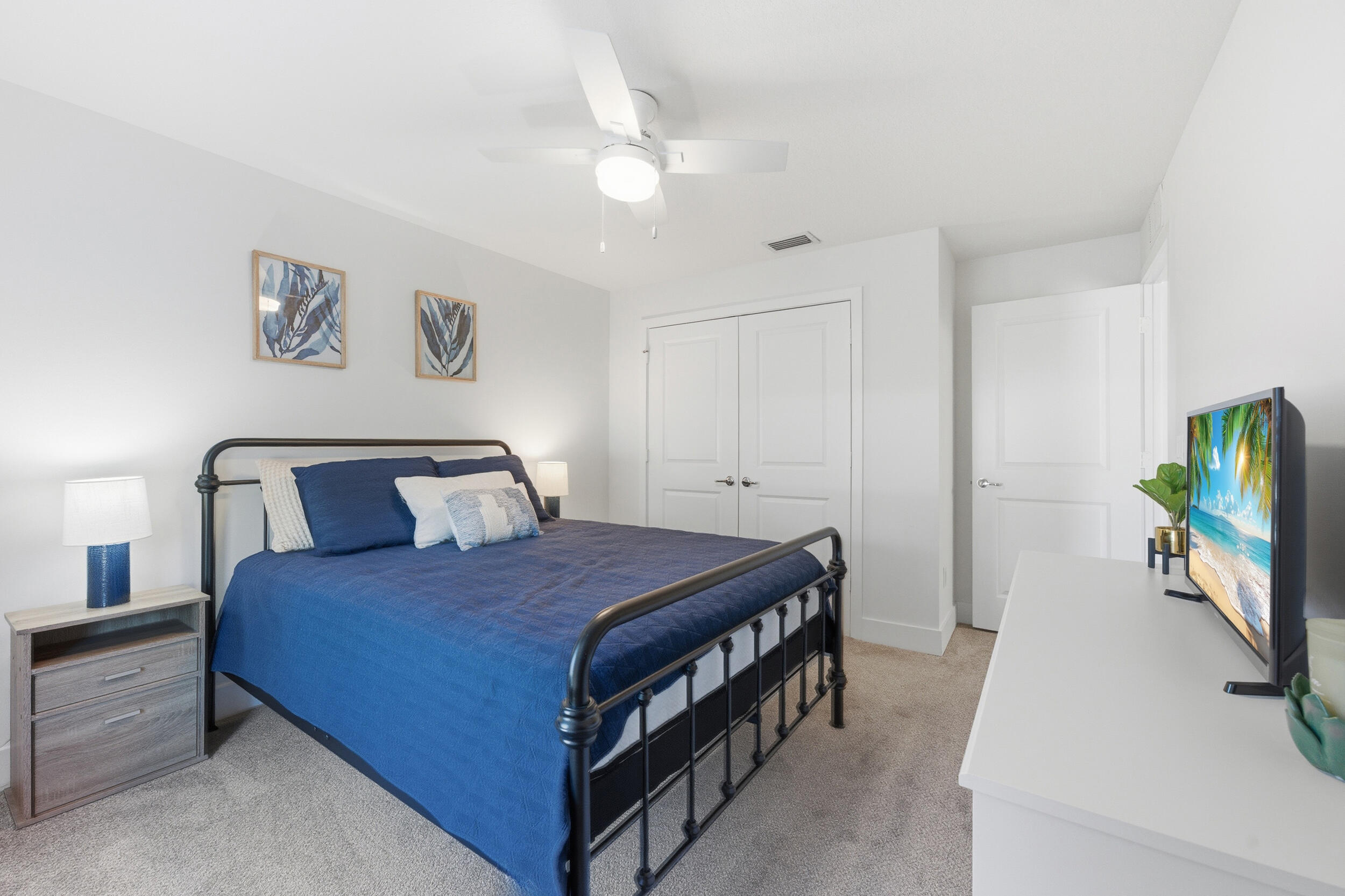 18932 42nd Road North The Acreage, FL 33470 - Photo 32 of 45 a bedroom with a bed and a flat tv screen on dresser