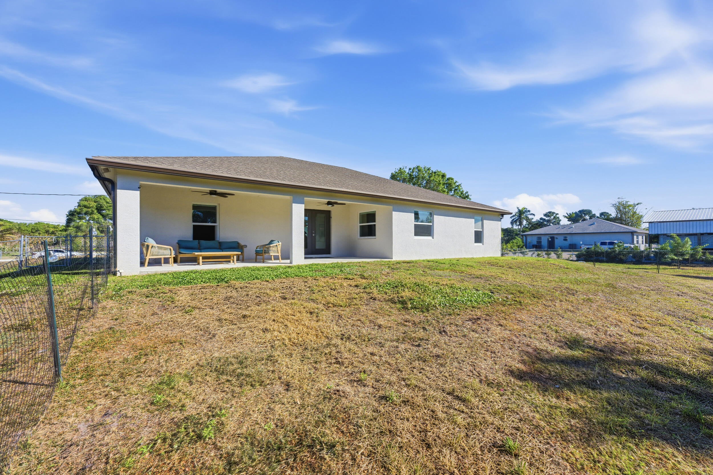 18932 42nd Road North The Acreage, FL 33470 - Photo 34 of 45 a view of house with backyard and deck