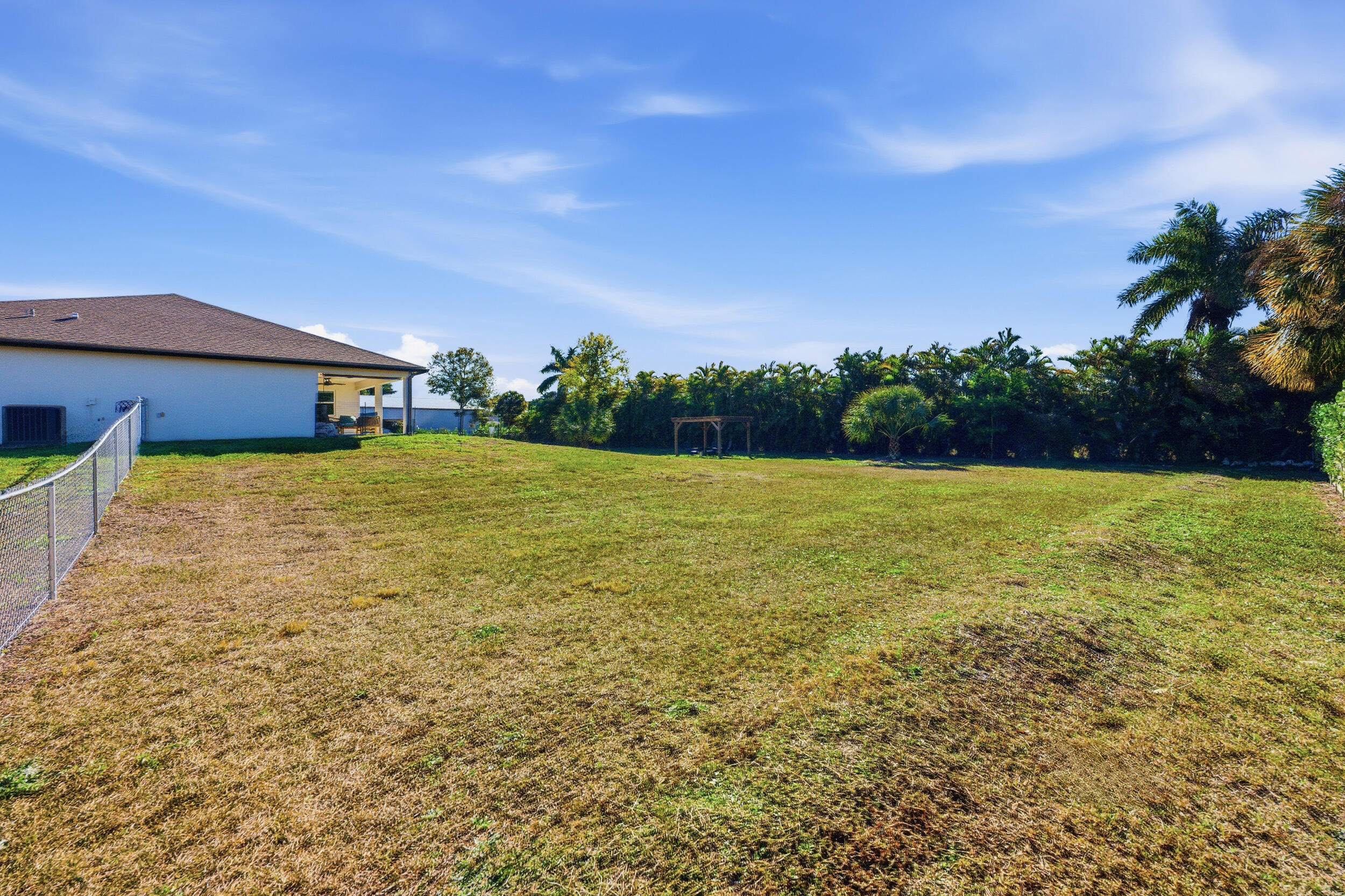 18932 42nd Road North The Acreage, FL 33470 - Photo 35 of 45 a view of a big yard with a house in the background
