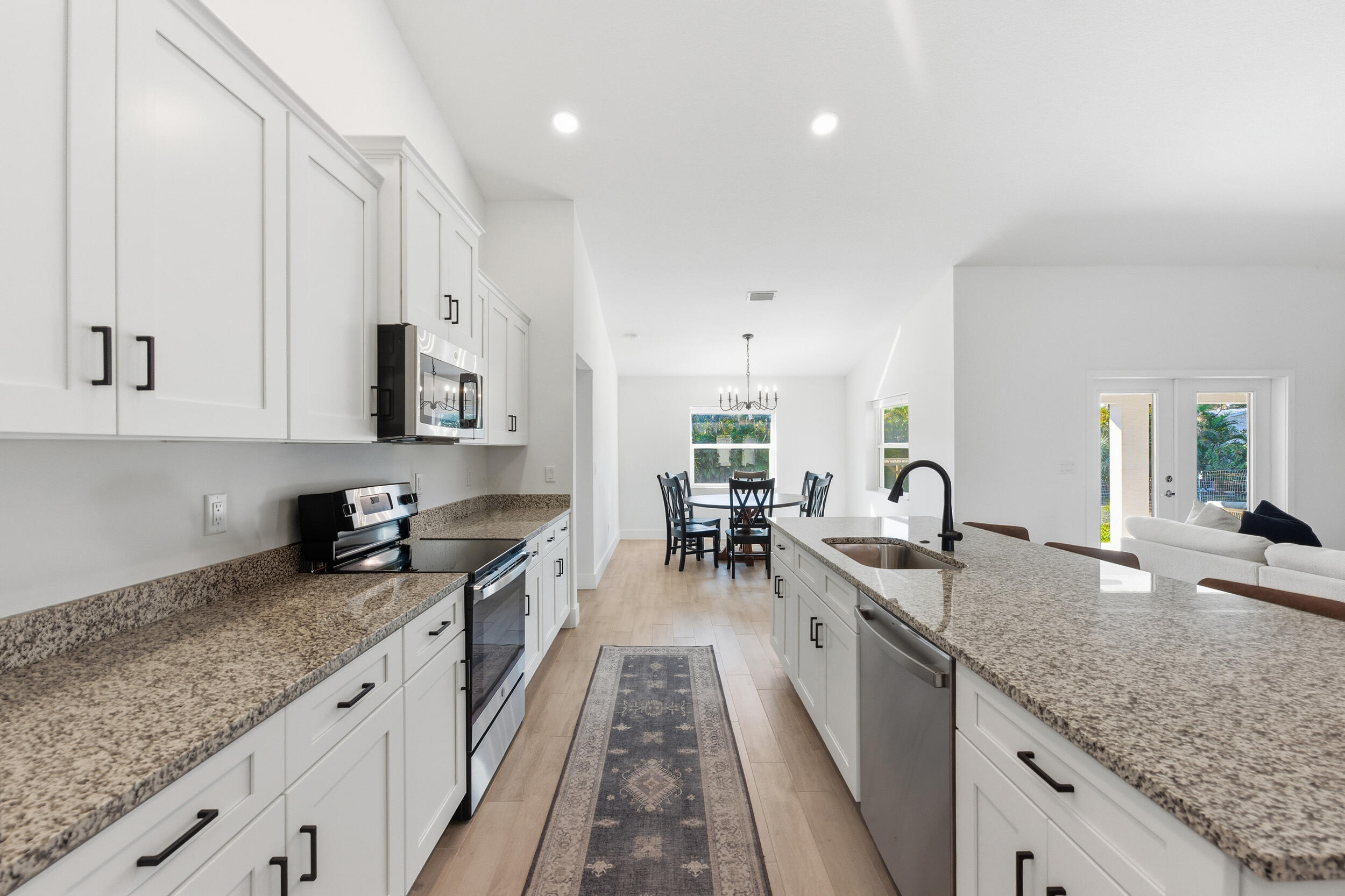 18932 42nd Road North The Acreage, FL 33470 - Photo 4 of 45 a kitchen with granite countertop a sink a counter top space appliances and cabinets