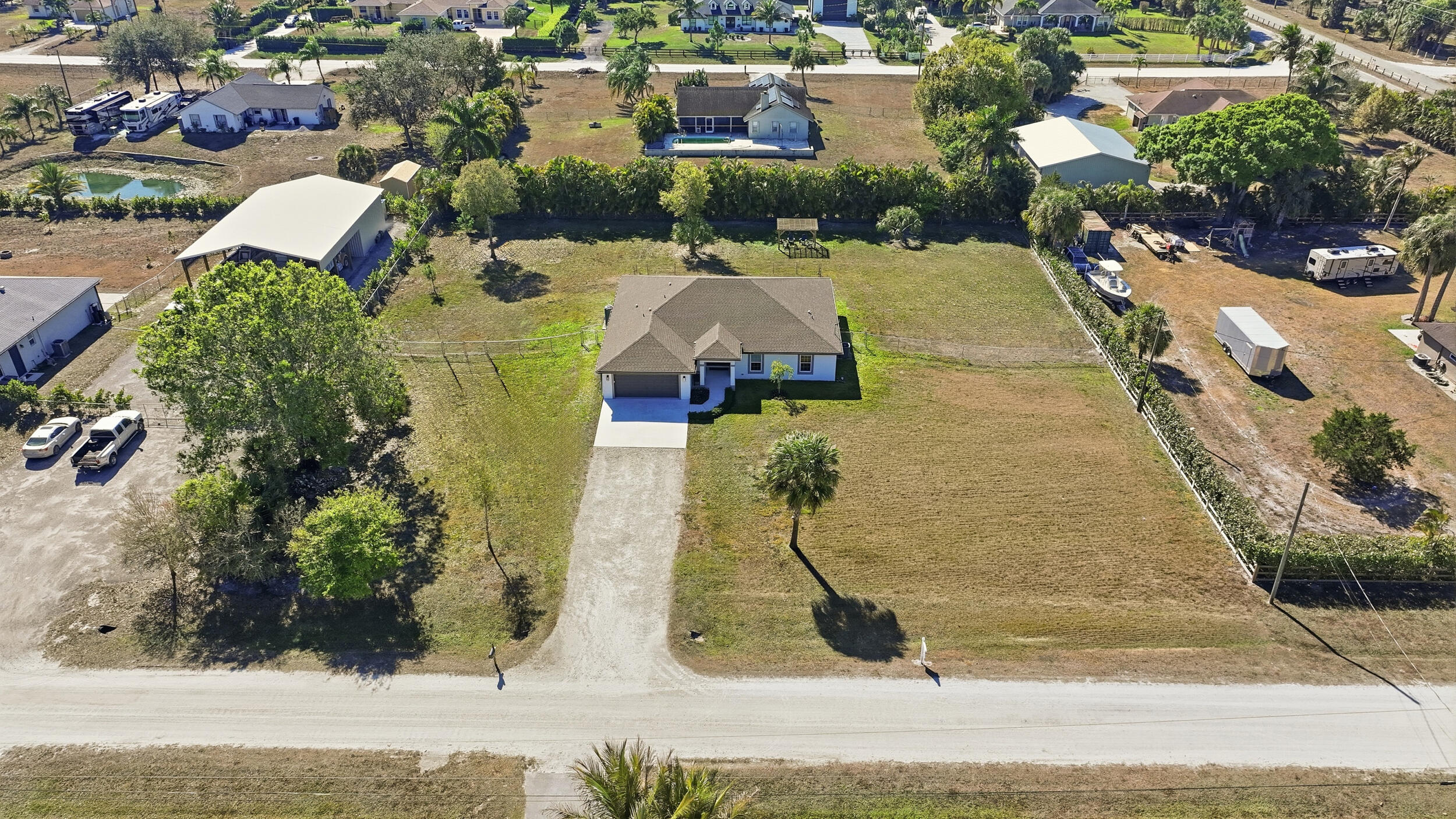 18932 42nd Road North The Acreage, FL 33470 - Photo 43 of 45 an aerial view of a house with a swimming pool
