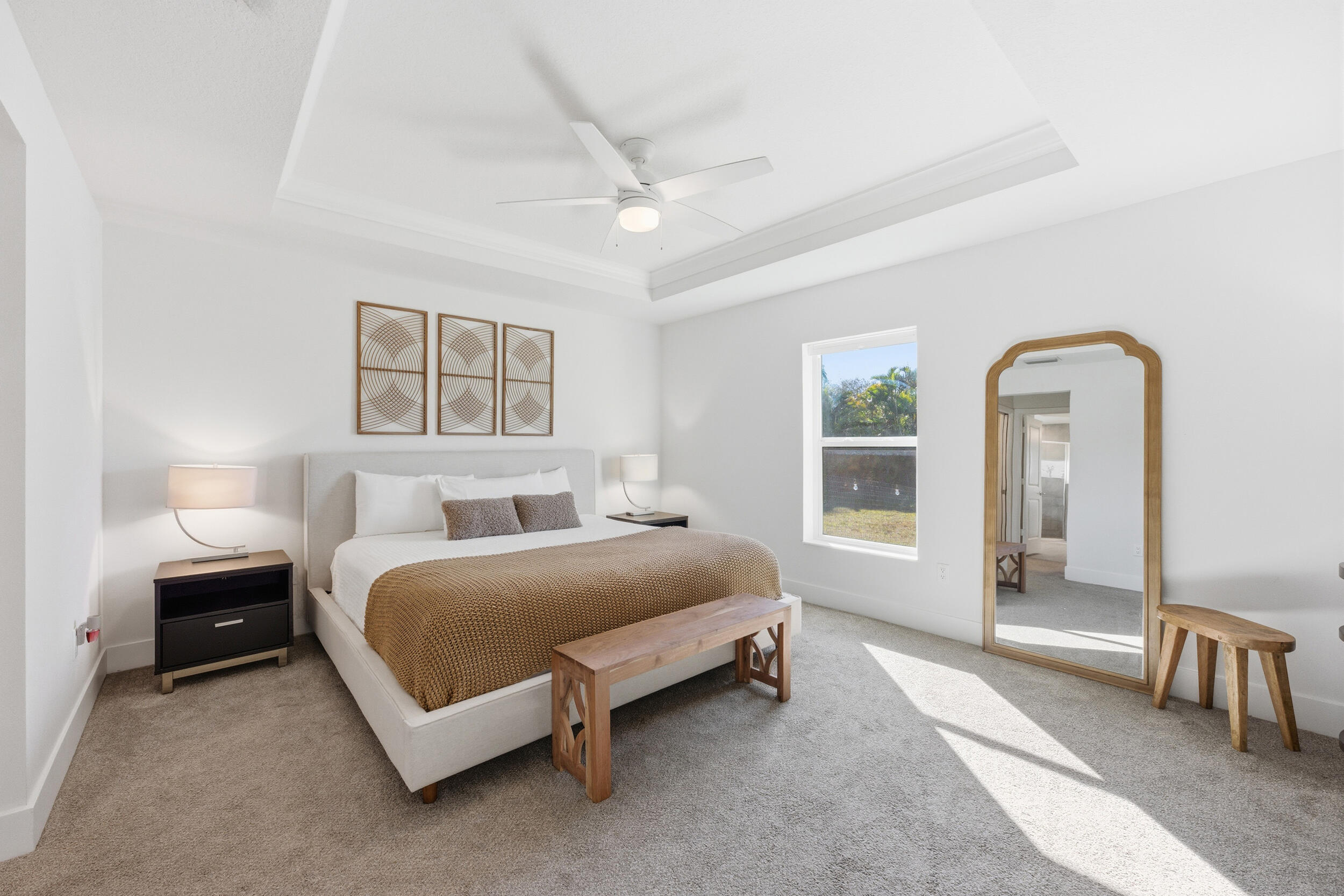 18932 42nd Road North The Acreage, FL 33470 - Photo 5 of 45 a spacious bedroom with a bed a table and painting