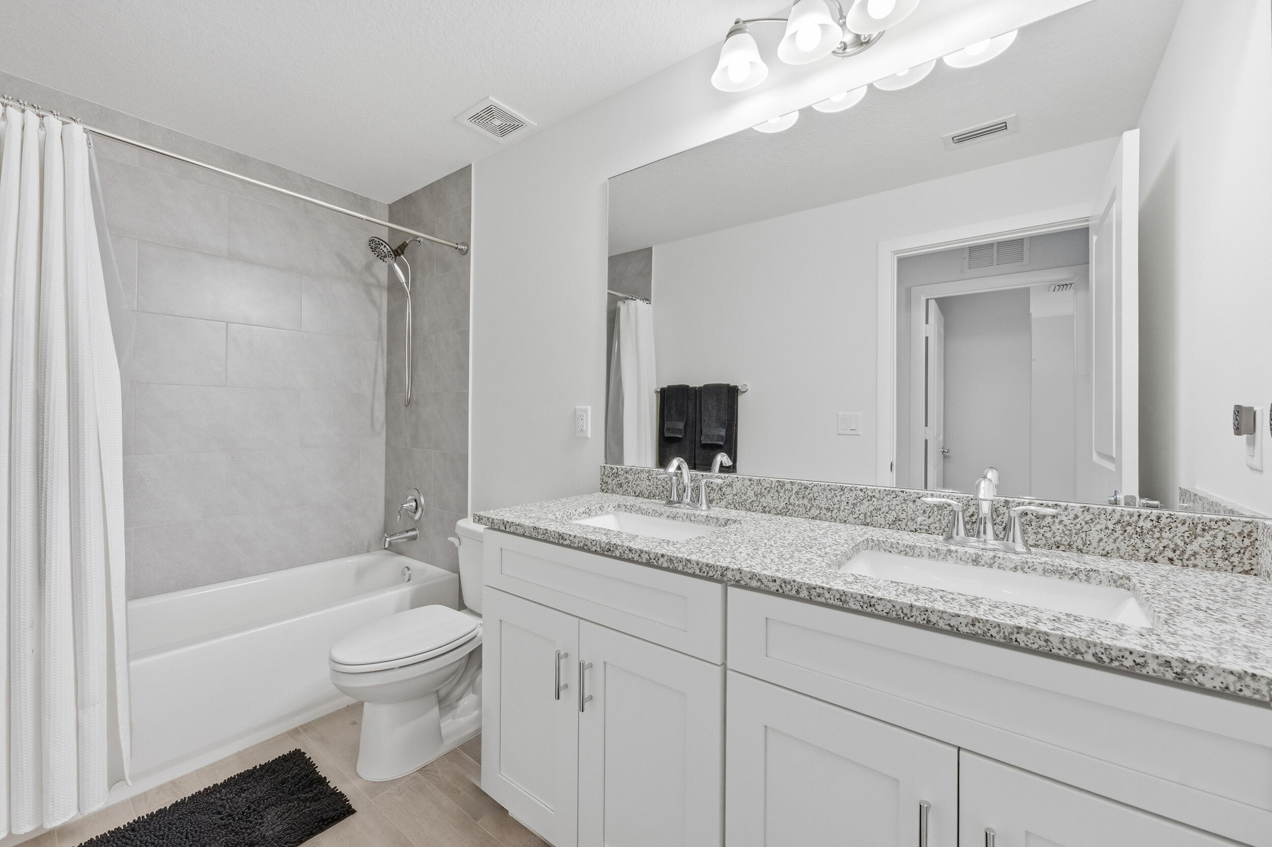 18932 42nd Road North The Acreage, FL 33470 - Photo 9 of 45 a bathroom with a granite countertop sink a toilet and a bathtub