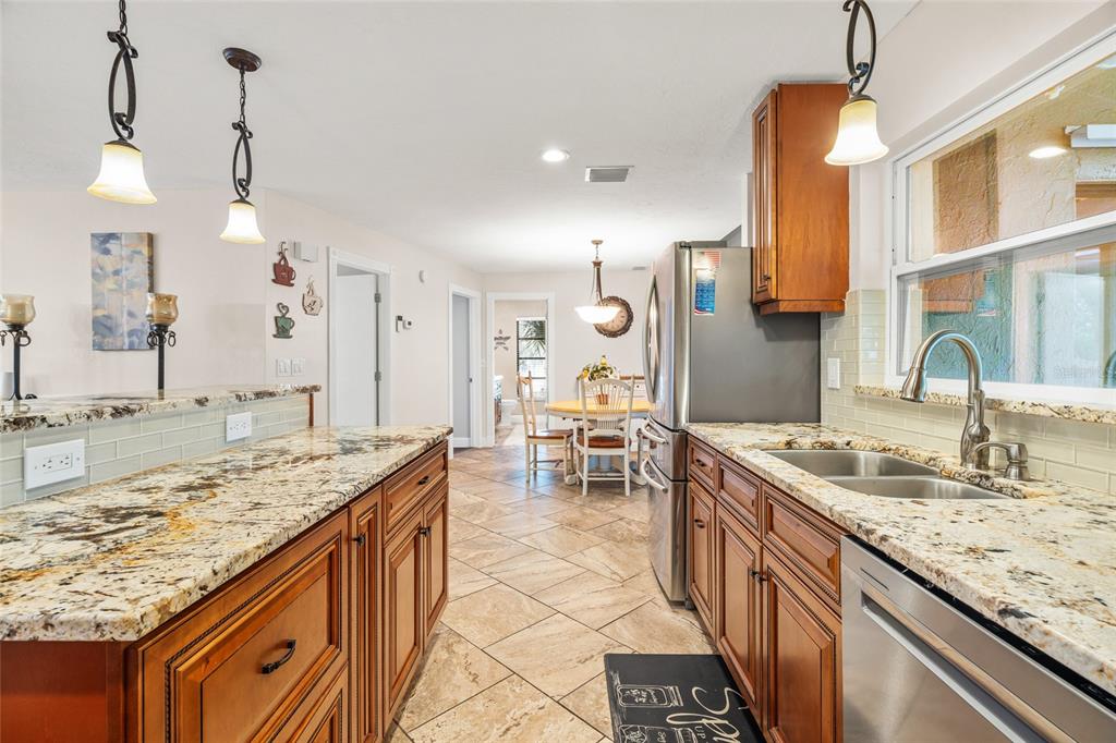4207 Charing Cross Road Sarasota, FL 34241 - Photo 13 of 36 a kitchen with kitchen island granite countertop a sink and a stove