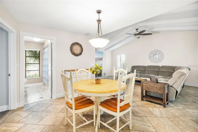 a view of a dining room with furniture and a chandelier