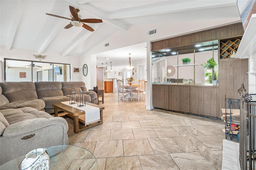 4207 Charing Cross Road Sarasota, FL 34241 - Photo 15 of 36 a living room with furniture and a dining table with chandelier
