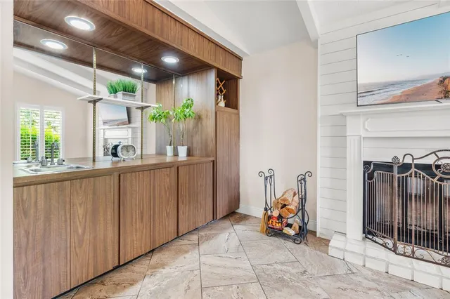 a view of kitchen with sink and refrigerator