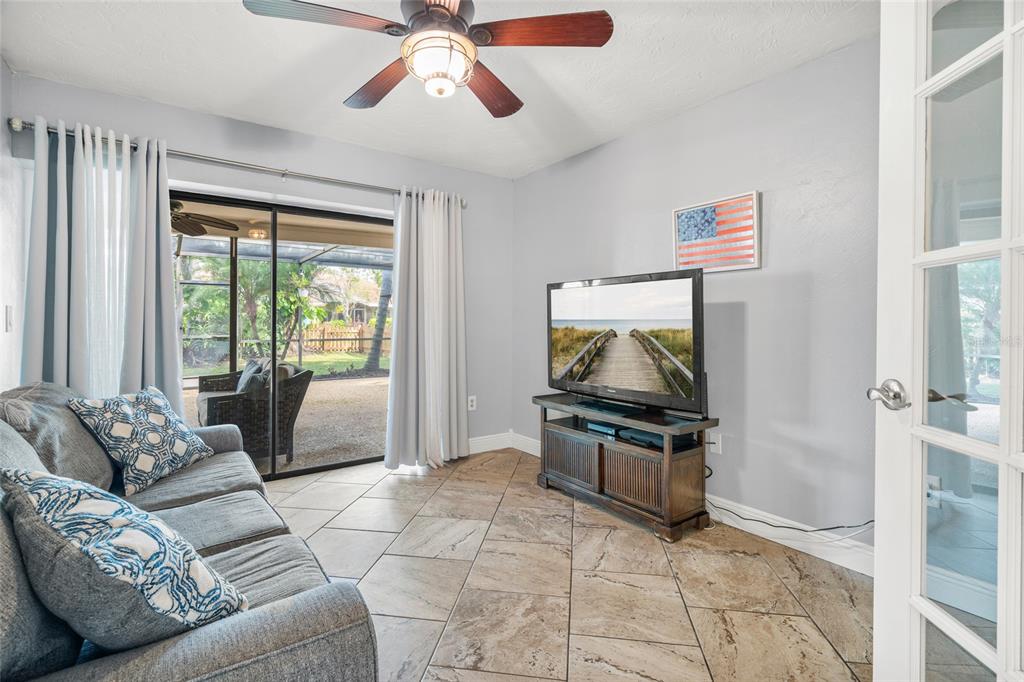 4207 Charing Cross Road Sarasota, FL 34241 - Photo 21 of 36 a living room with furniture and a flat screen tv