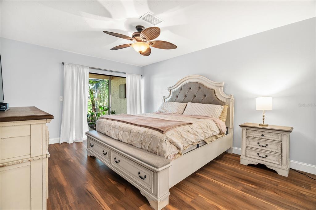 4207 Charing Cross Road Sarasota, FL 34241 - Photo 23 of 36 a bedroom with a bed and a chandelier