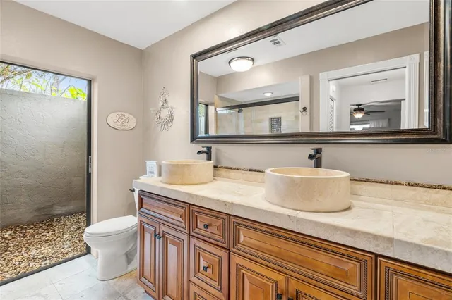 a bathroom with a shower toilet and sink