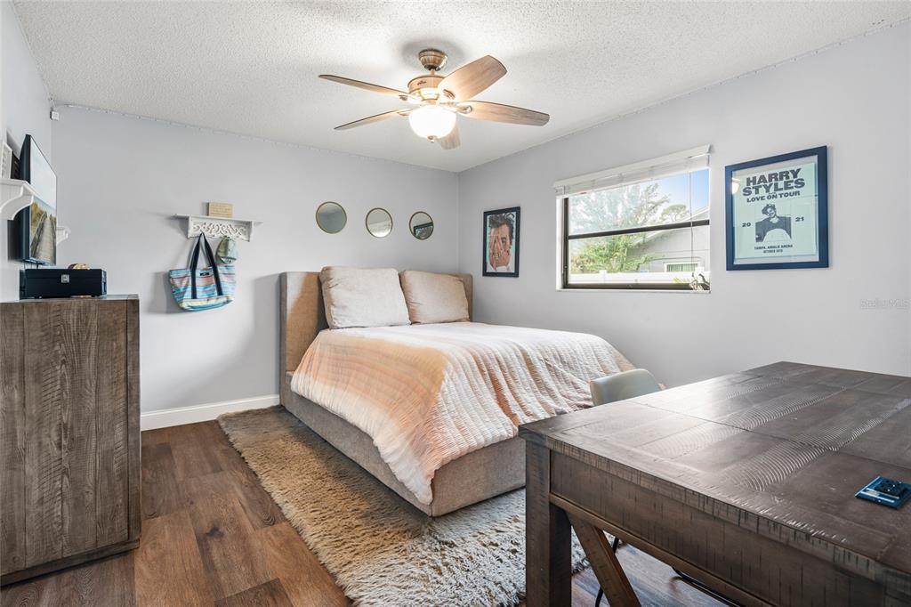 4207 Charing Cross Road Sarasota, FL 34241 - Photo 29 of 36 a bedroom with a bed and a chandelier