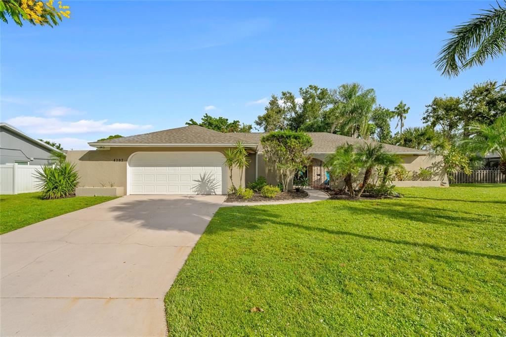 4207 Charing Cross Road Sarasota, FL 34241 - Photo 3 of 36 a front view of a house with garden