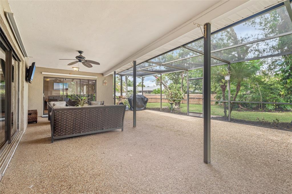 4207 Charing Cross Road Sarasota, FL 34241 - Photo 32 of 36 a living room with couch and a floor to ceiling window