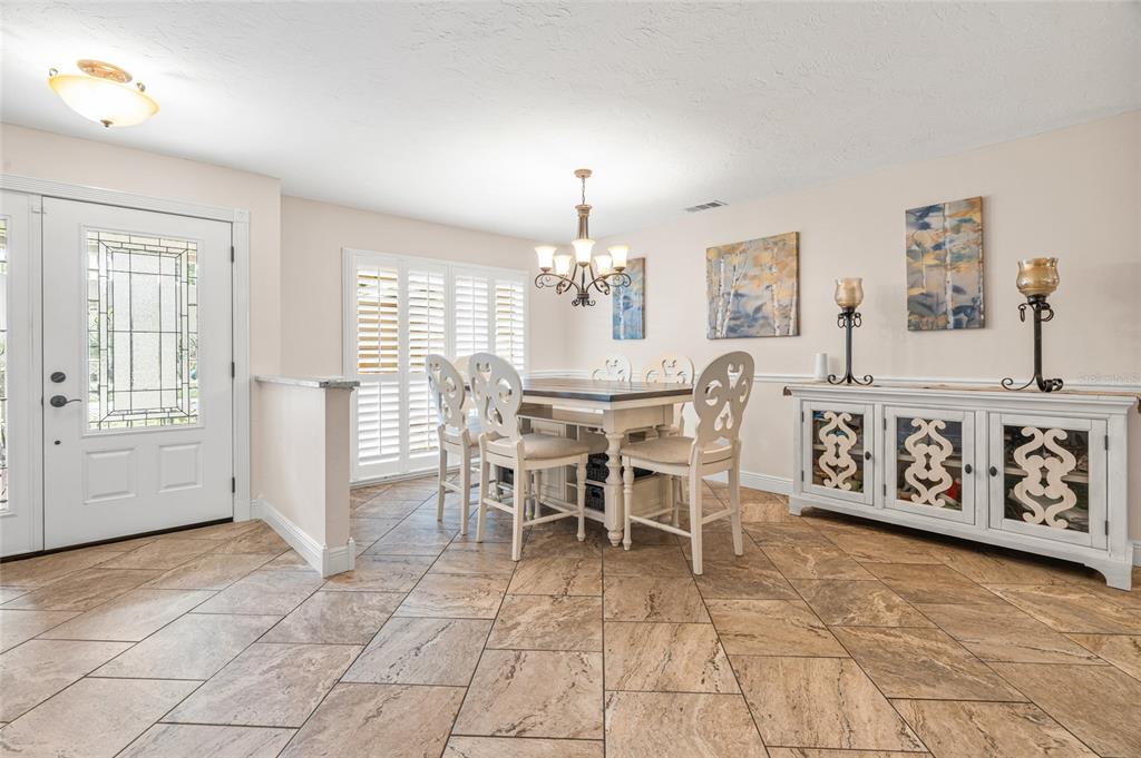 4207 Charing Cross Road Sarasota, FL 34241 - Photo 6 of 36 a view of a dining room with furniture and chandelier