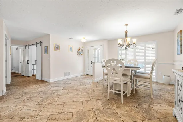 a view of a dining room with furniture and chandelier
