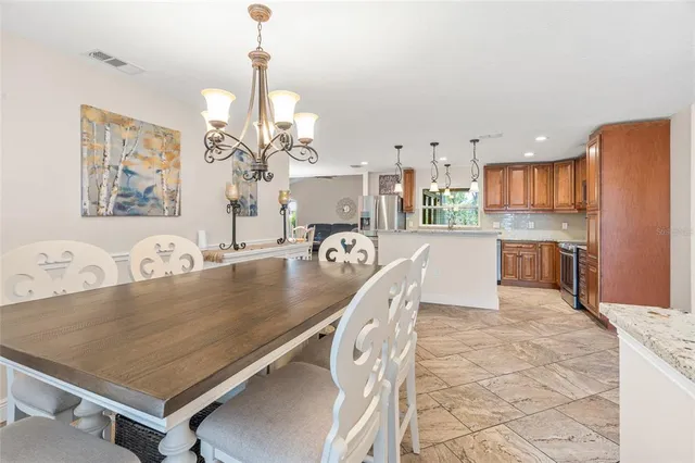 a large kitchen with kitchen island a table and chairs in it