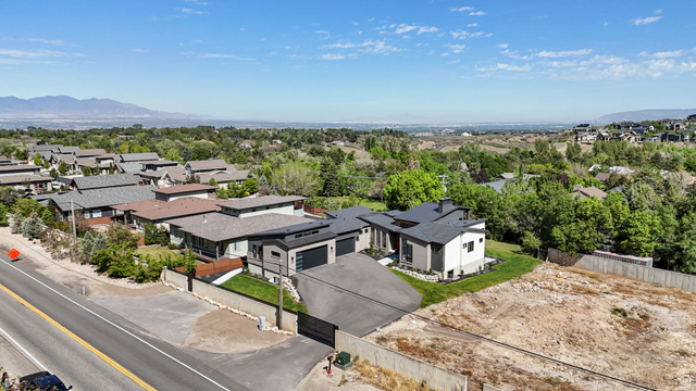 3667 Little Cottonwood Road, Unit 1 Sandy, UT 84092 - Photo 41 of 49 Contemporary residential property featuring a dark-tiled roofline, a light-colored exterior finish, and a red front door