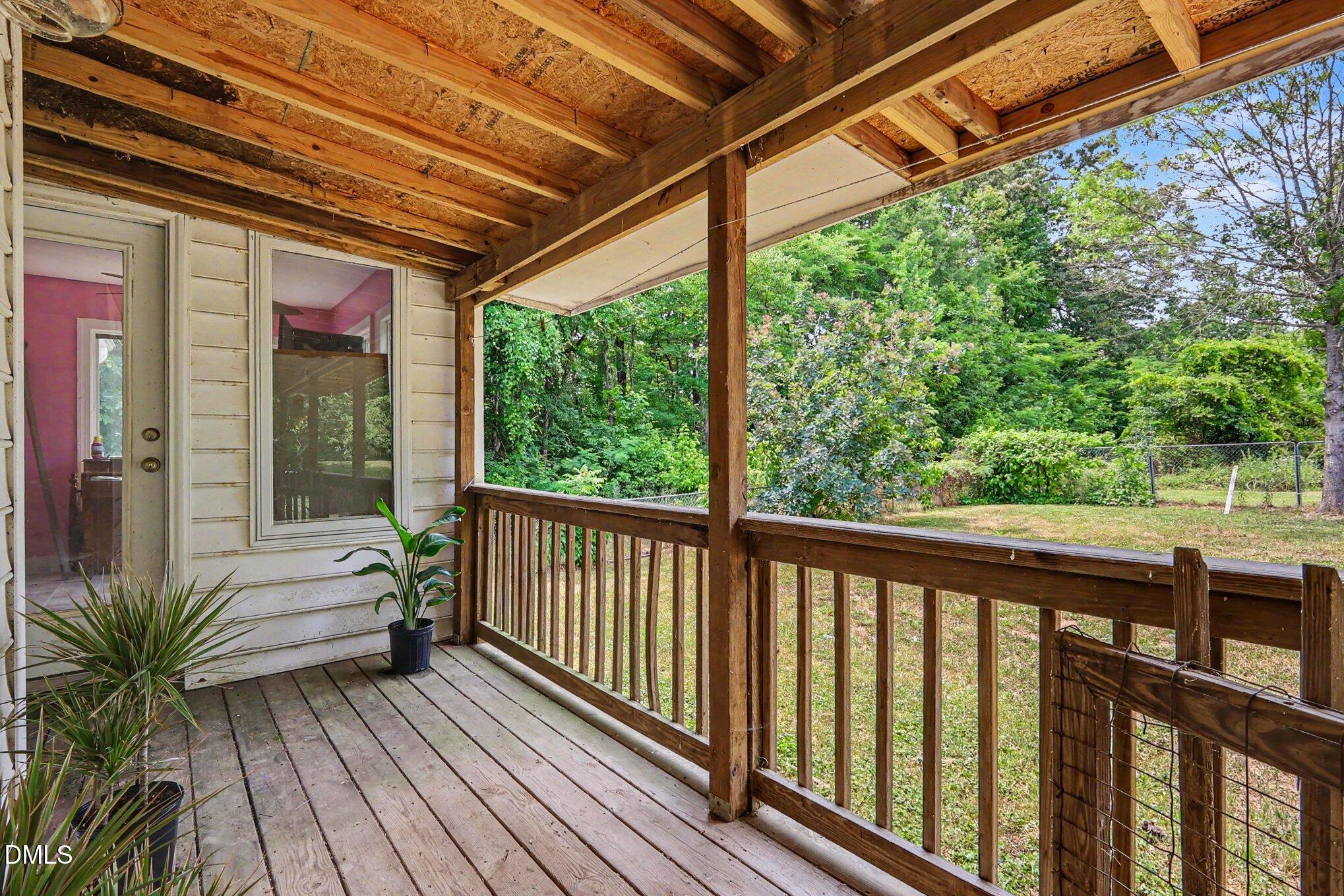 1750 Tom Oakley Road Timberlake, NC 27583 - Photo 22 of 31 a porch with wooden floor in front of a house