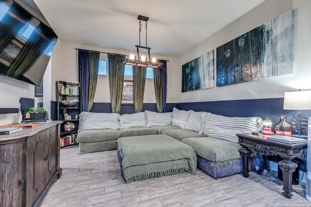 a living room with furniture and a chandelier