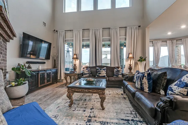 a living room with furniture fireplace and flat screen tv