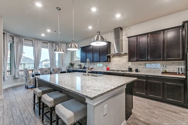 a large kitchen with a table and chairs