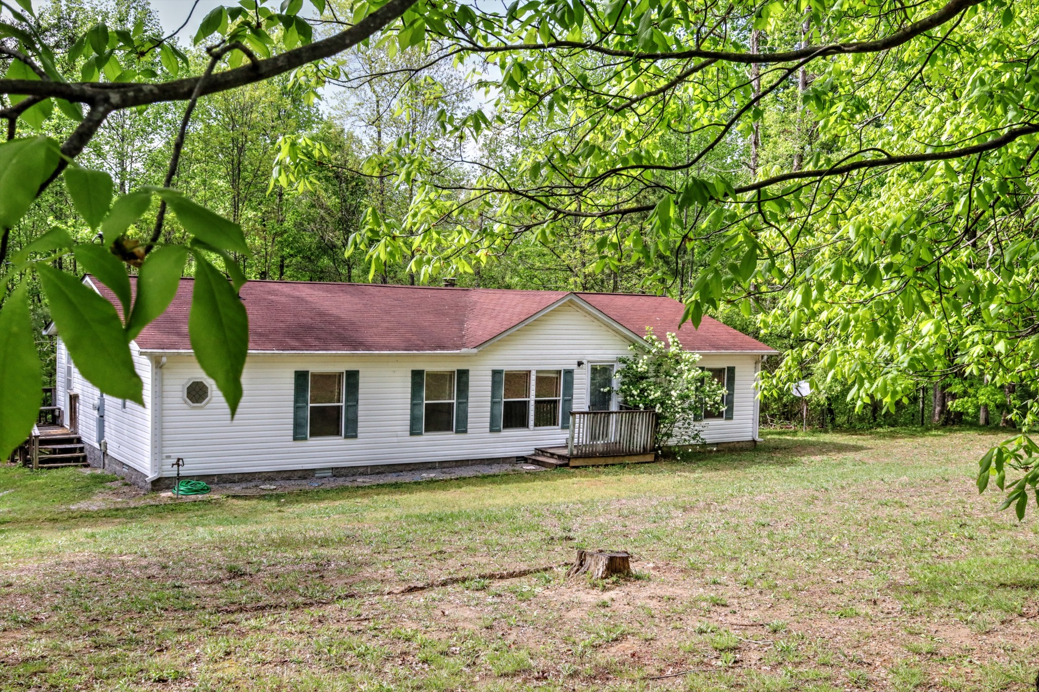 5090 Old Marion Road Cunningham, TN 37052 - Photo 1 of 21 a front view of a house with a garden and yard