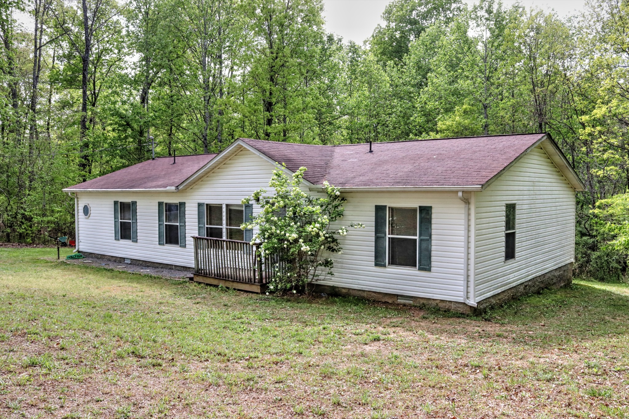 5090 Old Marion Road Cunningham, TN 37052 - Photo 2 of 21 a front view of a house with a garden