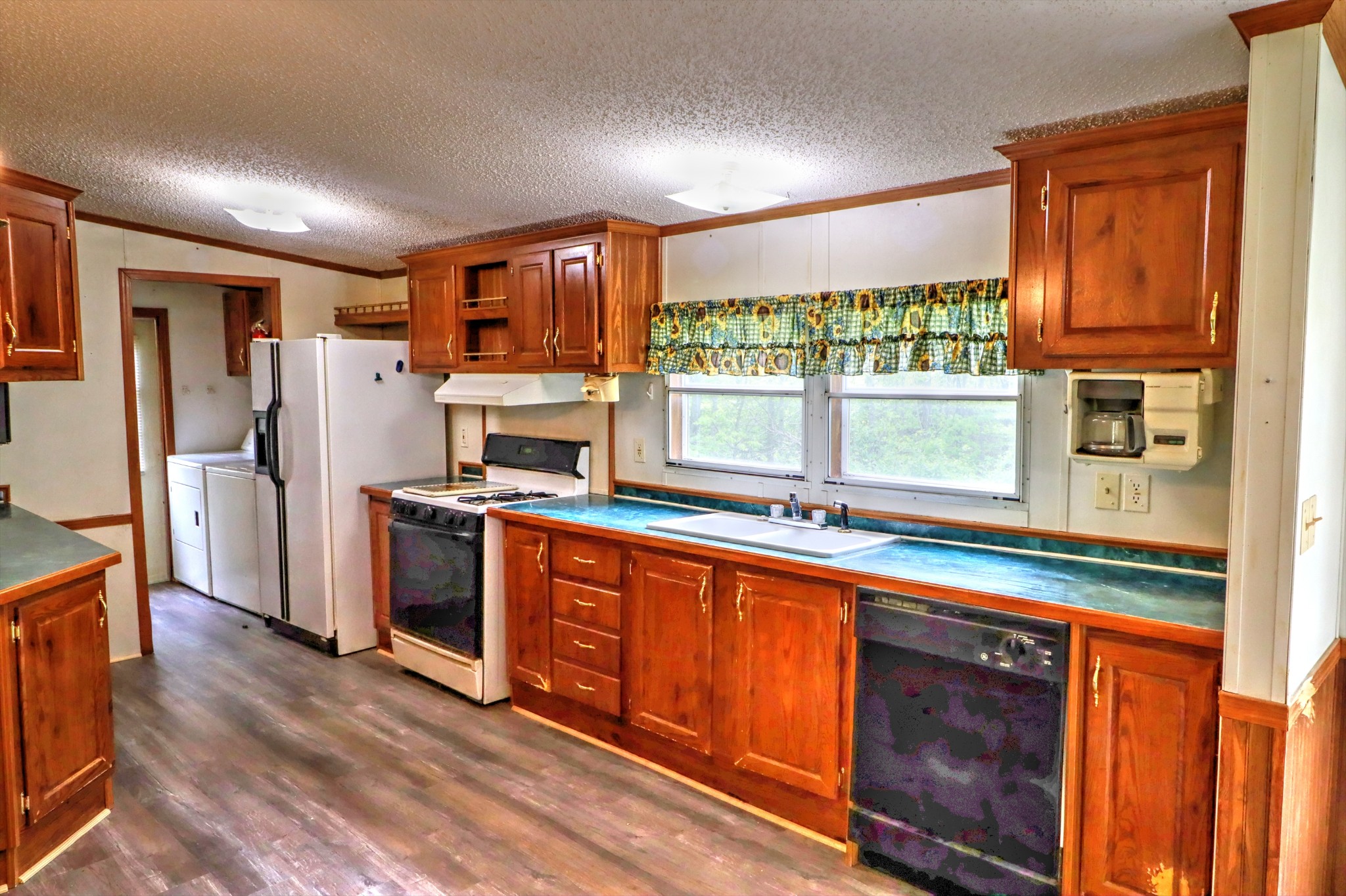 5090 Old Marion Road Cunningham, TN 37052 - Photo 9 of 21 a kitchen with stainless steel appliances granite countertop a refrigerator a stove a sink and a window