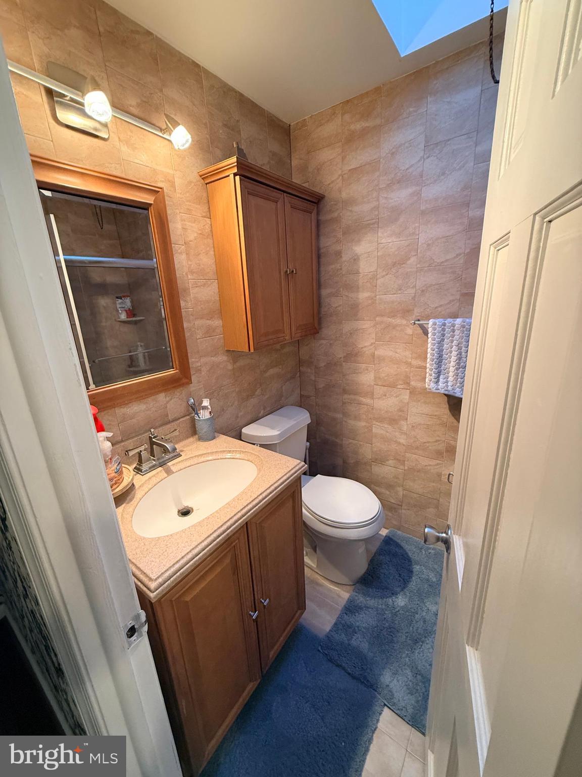 426 Parlin Street Philadelphia, PA 19116 - Photo 21 of 27 a bathroom with a sink a toilet a mirror and shower
