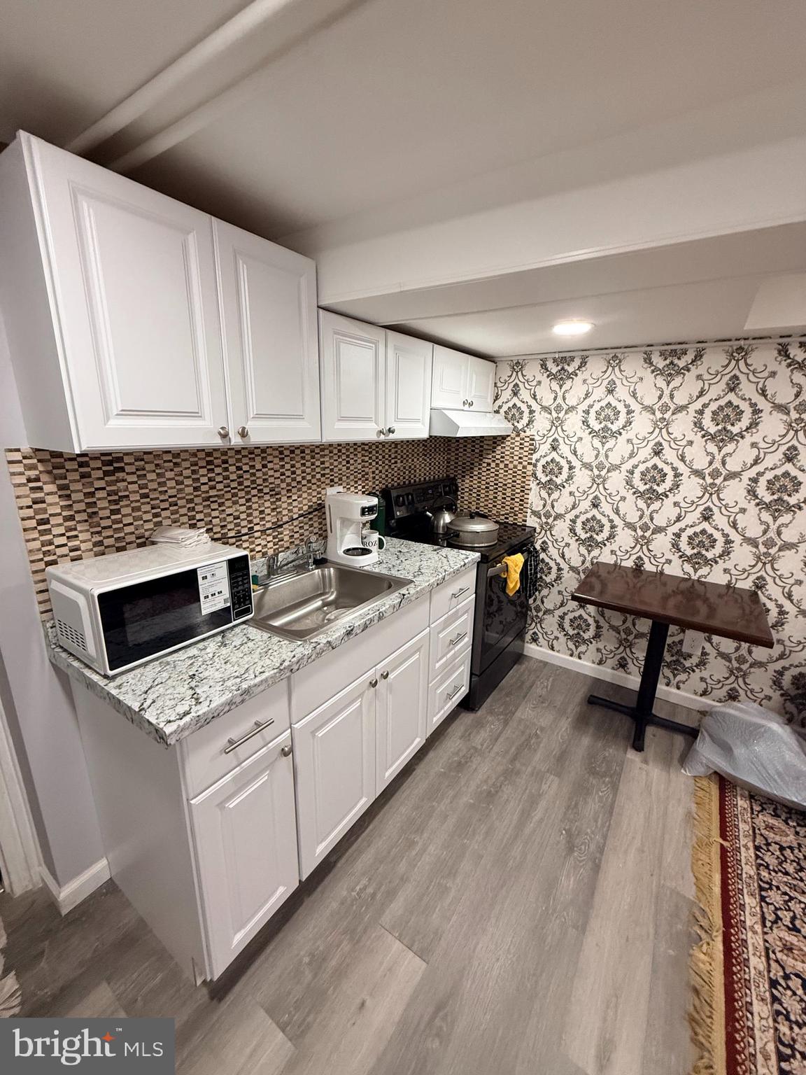 426 Parlin Street Philadelphia, PA 19116 - Photo 4 of 27 a kitchen with a stove a sink and a microwave