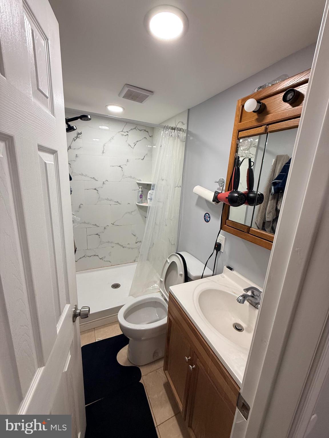 426 Parlin Street Philadelphia, PA 19116 - Photo 8 of 27 a bathroom with a sink and a mirror